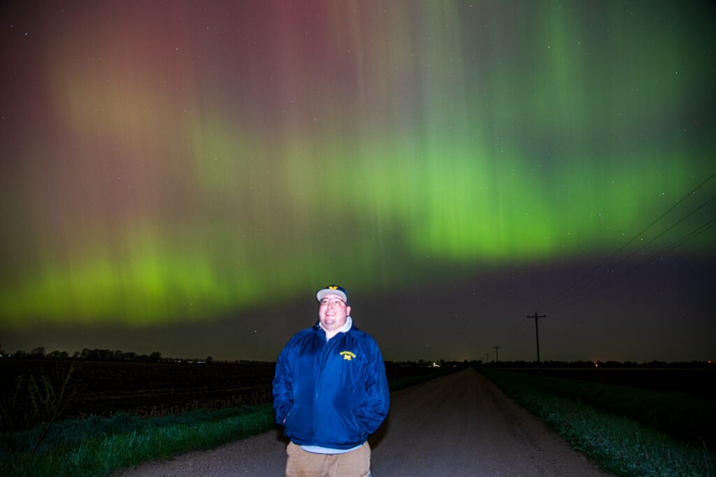 Ben Holcomb standing under Auroras in northeast Nebraska on May 10, 2024
